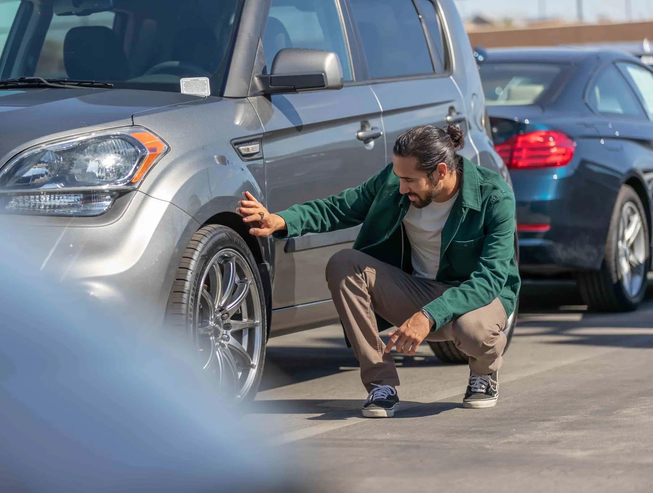 Man inspecting car tire