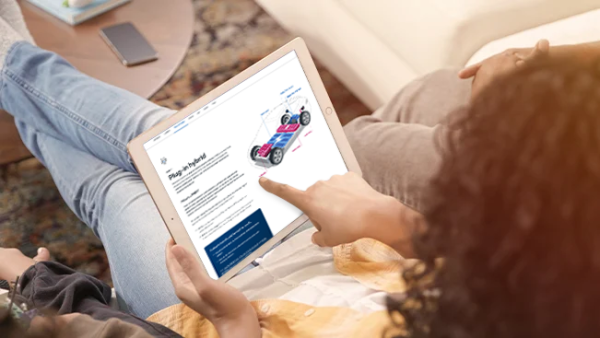 Woman on tablet viewing CarMax's Powertrains and fuel types page