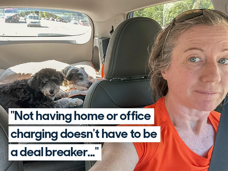 A woman in the driver's seat of a Chevrolet Bolt takes a selfie. She wears an orange tank top and sunglasses on the crown of her head. Two dogs sleep in the back of the car. Quote overlaid on image reads "Not having home or office charging doesn't have to be a deal breaker..."