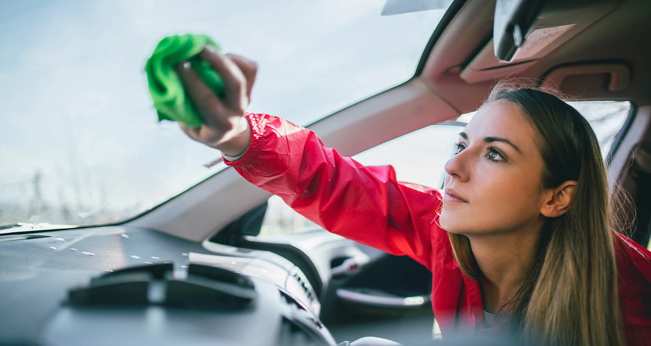 Woman cleaning windshield 