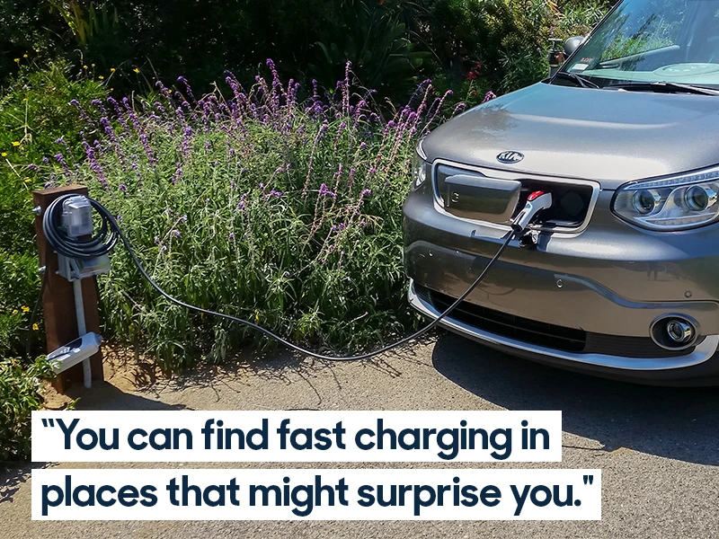 2016 Kia Soul charging next to flower bed. Caption reads "You can find fast charging in place that might surprise you." 