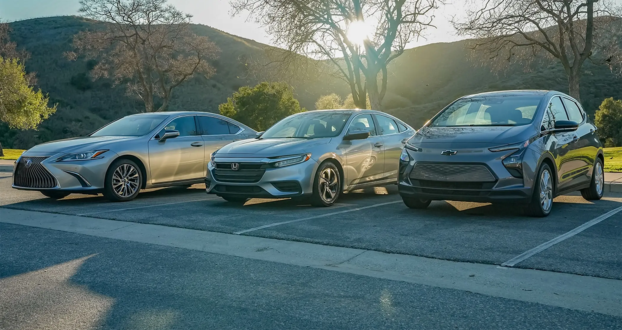 Line up of commuter cars Lexus ES, Honda Insight and Chevrolet Bolt