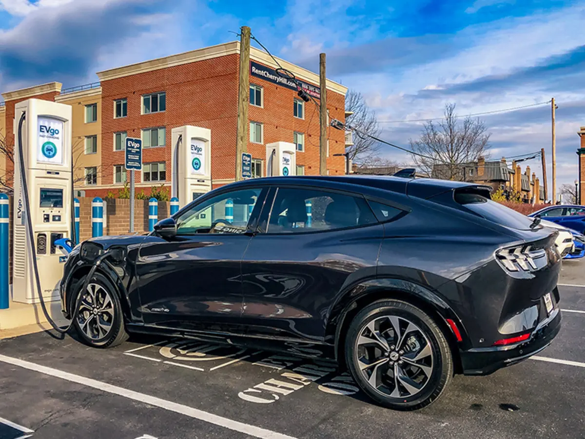 Black 2021 Mustang Mach-E plugged in at an EV charging station