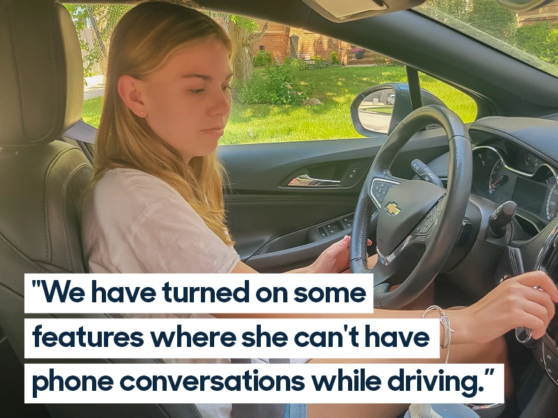 Teenage driver sitting behind the wheel of a 2017 Chevrolet Cruze adjusting a dial. Quote reads "We have turned on some features where she can't have phone conversations while driving."