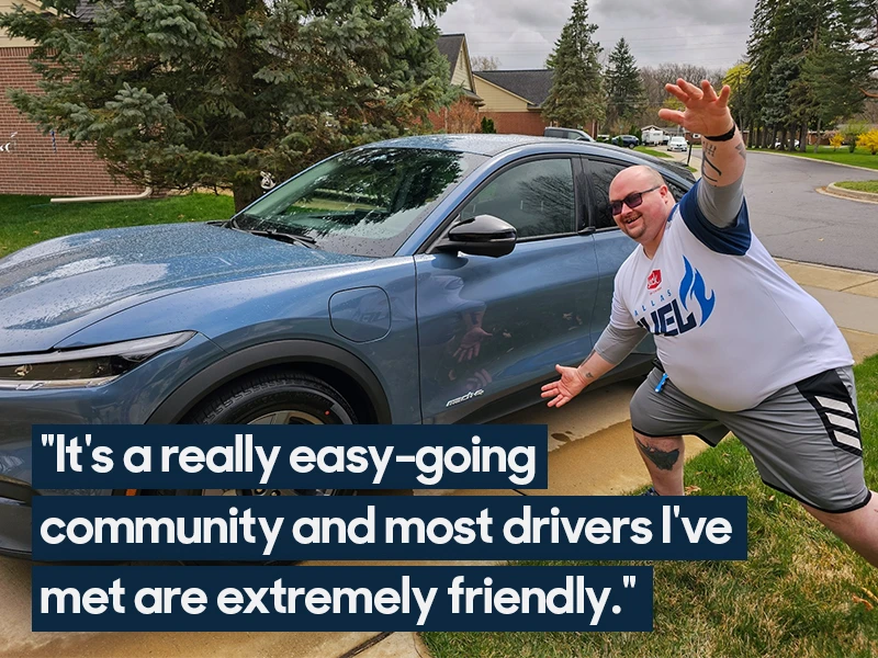 A man poses enthusiastically in front of his blue Ford Mustang Mach-E. Quote overlaid on the image reads "It's a really easy-going community and most drivers I've met are extremely friendly."