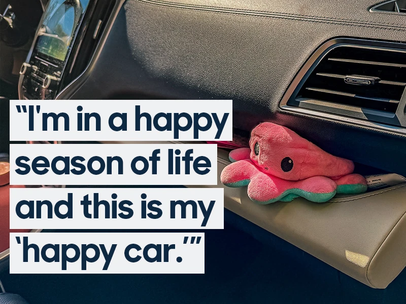 An octopus stuffed toy sits wedged on the dashboard of a Subaru Ascent. Text overlaid on the image reads "I'm in a happy season of life and this is my 'happy car.'"