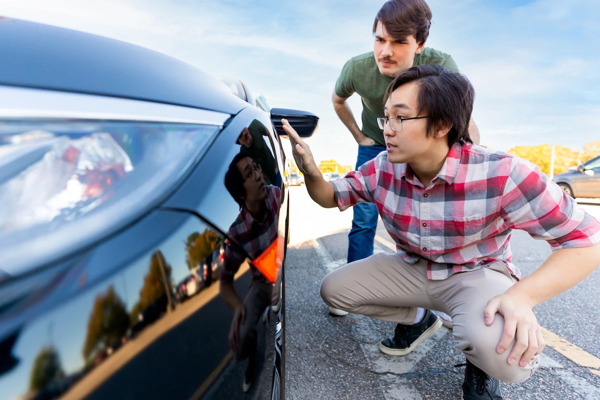 Two men inspecting car