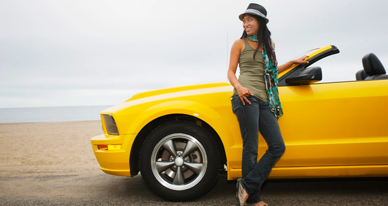 127 Best Used Cars for 2022: Woman leaning against sports car | CarMax