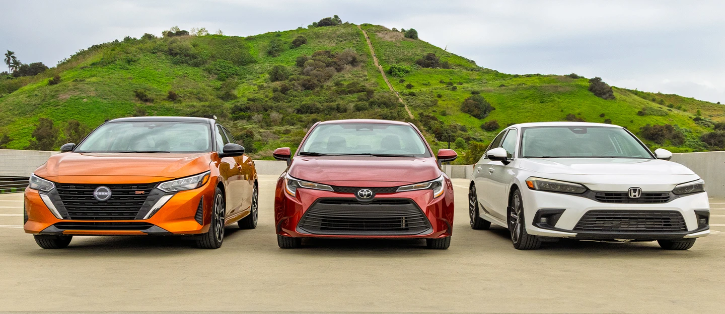 Compact Sedans lined up orange Nissan Sentra, red Toyota Corolla, white Honda Civic