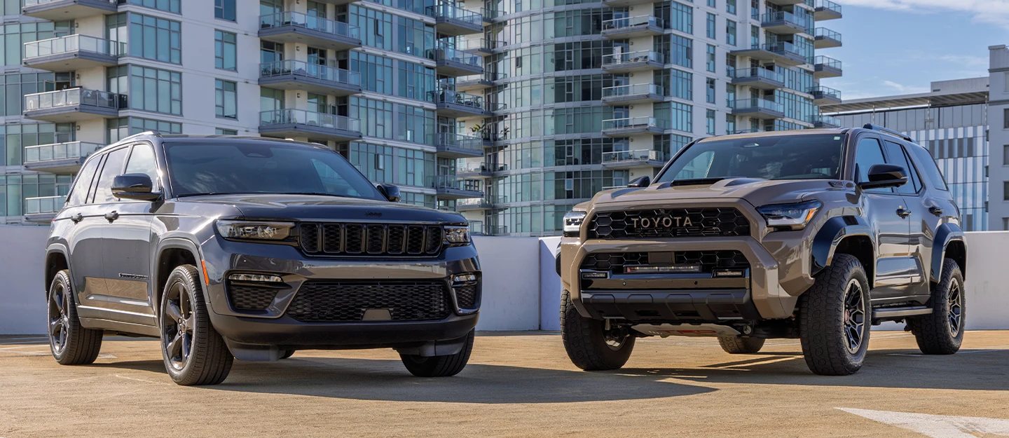 Jeep Grand Cherokee vs Toyota 4Runner parked side by side on a rooftop